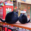 Peluche chaton noir aux grands yeux
