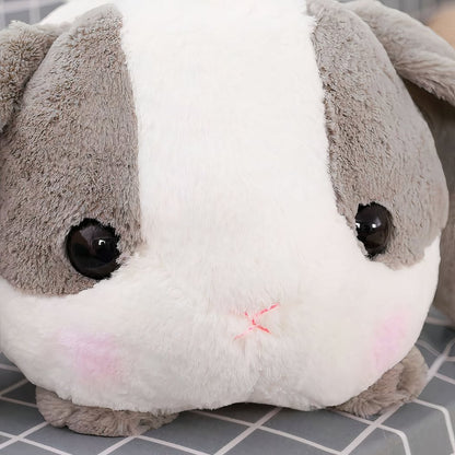 Peluche lapin gris couché