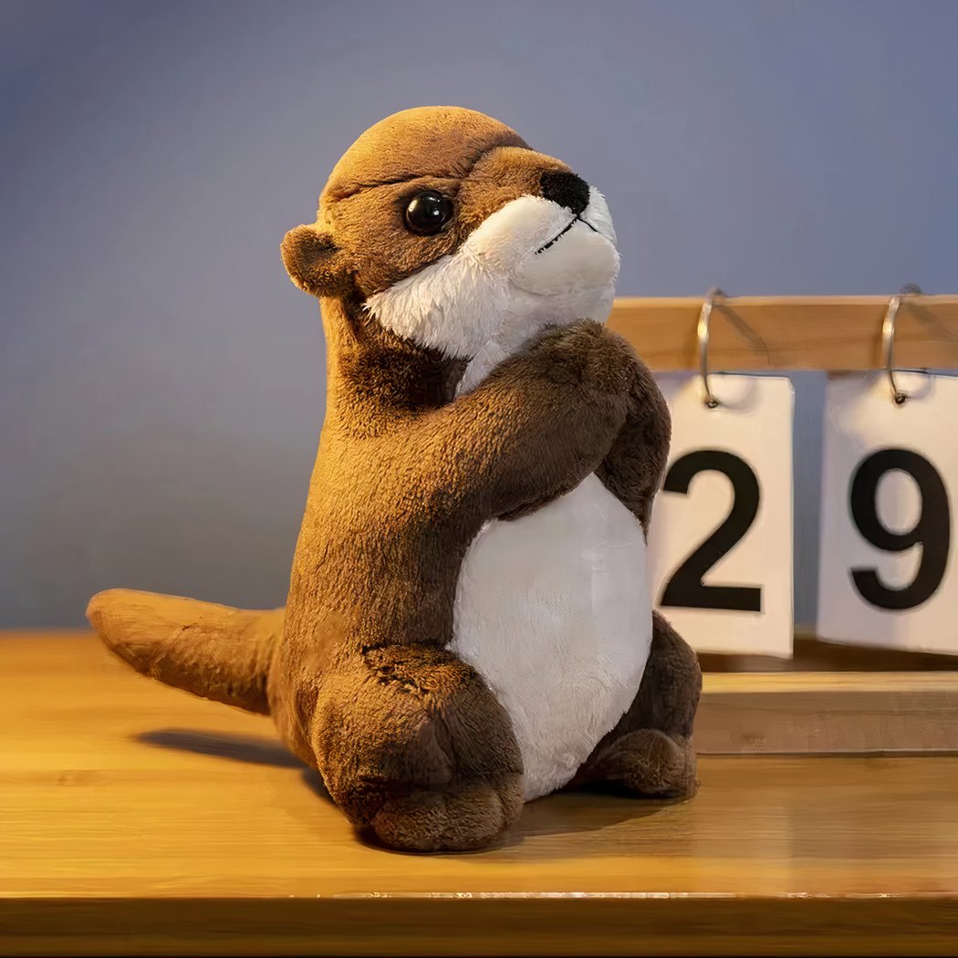 Petite peluche loutre en prière