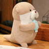 Beige otter plush holding its light blue fish toy