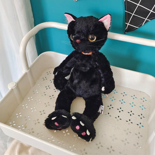 Peluche chat noir mécontent assis