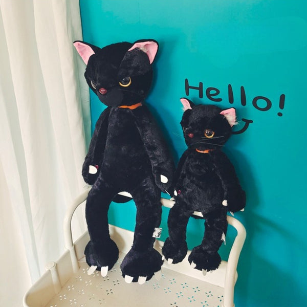 Peluche chat noir mécontent assis